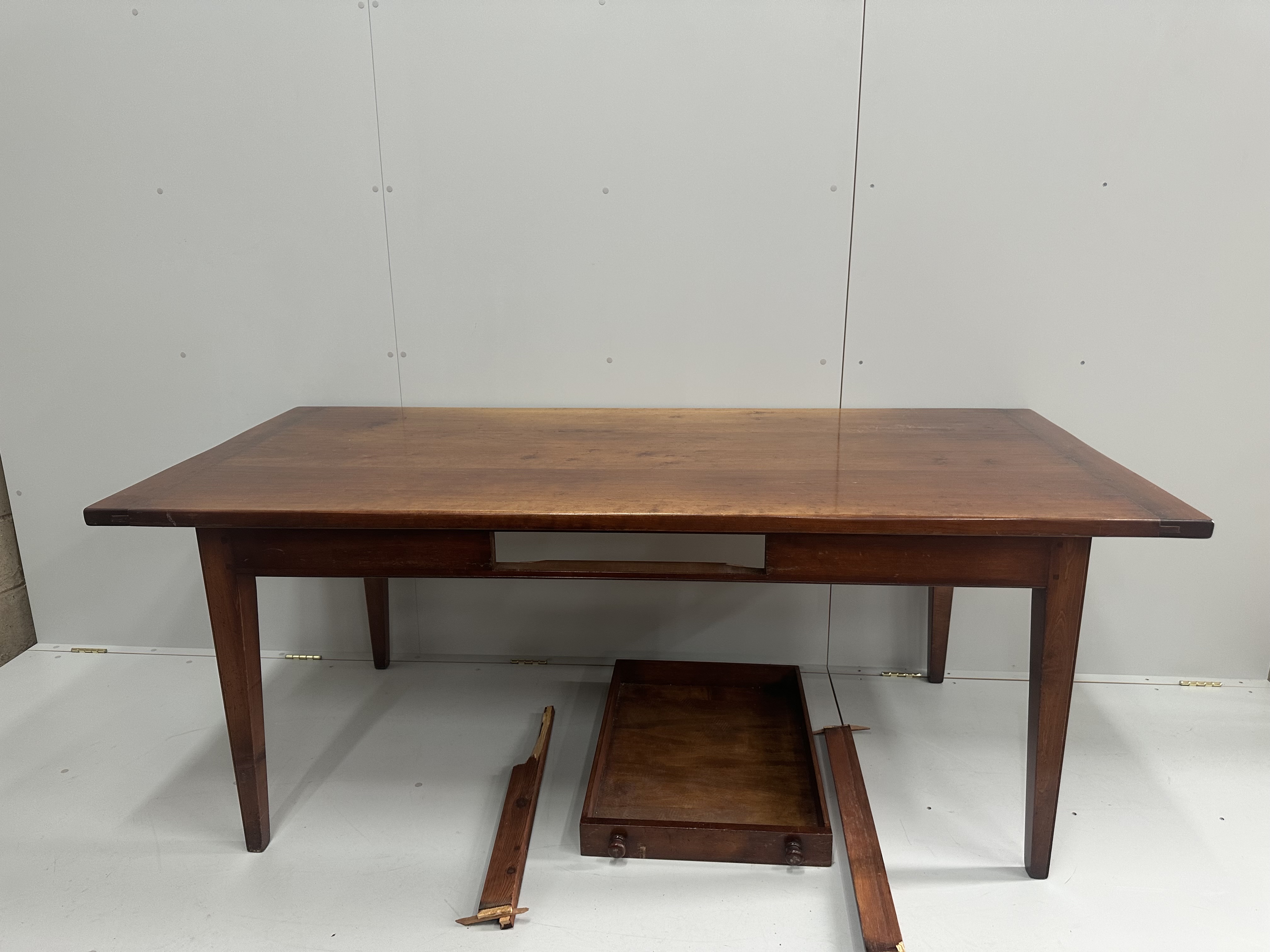 A reproduction French Provincial style rectangular farmhouse table, with single extension, drawer runners in need of restoration, length 248cm extended, depth 90cm, height 76cm